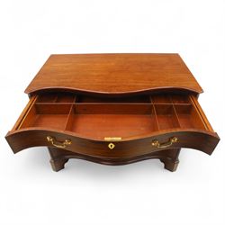 George III mahogany serpentine chest, moulded top over four cock-beaded drawers, the top drawer fitted with baize lined slide opening to reveal divisions,  enclosed by canted and fluted upright corners, the drawer fronts fitted with brass swan neck handles and circular plates with oval escutcheons, lower moulded edge over bracket feet, on lignum vitae castors