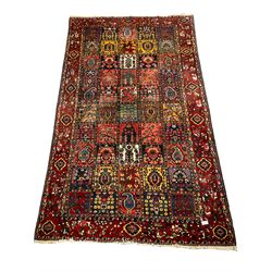 Large Persian garden rug, multiple rectangular panels decorated with stylised plants, Boteh and tree of life motifs, the outer guarded border with floral design 