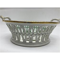 Pair of 19th century German openwork chestnut baskets, with twin handles and scrolling gilt border and star rim, painted to the centre with birds and insects, D22cm 