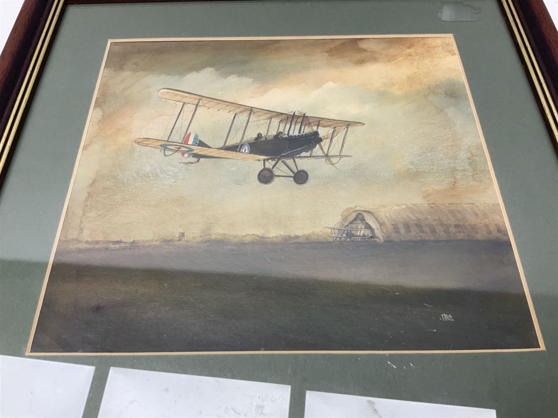 T. Page (early 20th century) - RFC bi-plane in flight over an airfield, bears labels verso 'BE2.B. Dennes Lane R.F.C. Lydd Flying School Oct.1916' and 'Lt. Gerrard R.F.C Lydd 1917 Evening Anti Zeppelin Training Flt. B. Dennes Lane Circum & Bumps', signed watercolour 20.5 x 22.5cm, later mahogany stained frame