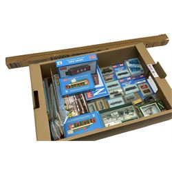 Peco N-gauge - twelve goods wagons in hard plastic cases; various unassembled kits including Country Stations, Engine Sheds, Platform Shelter, goods wagons etc; assorted track and points; and a Faller Platform Roofing kit
