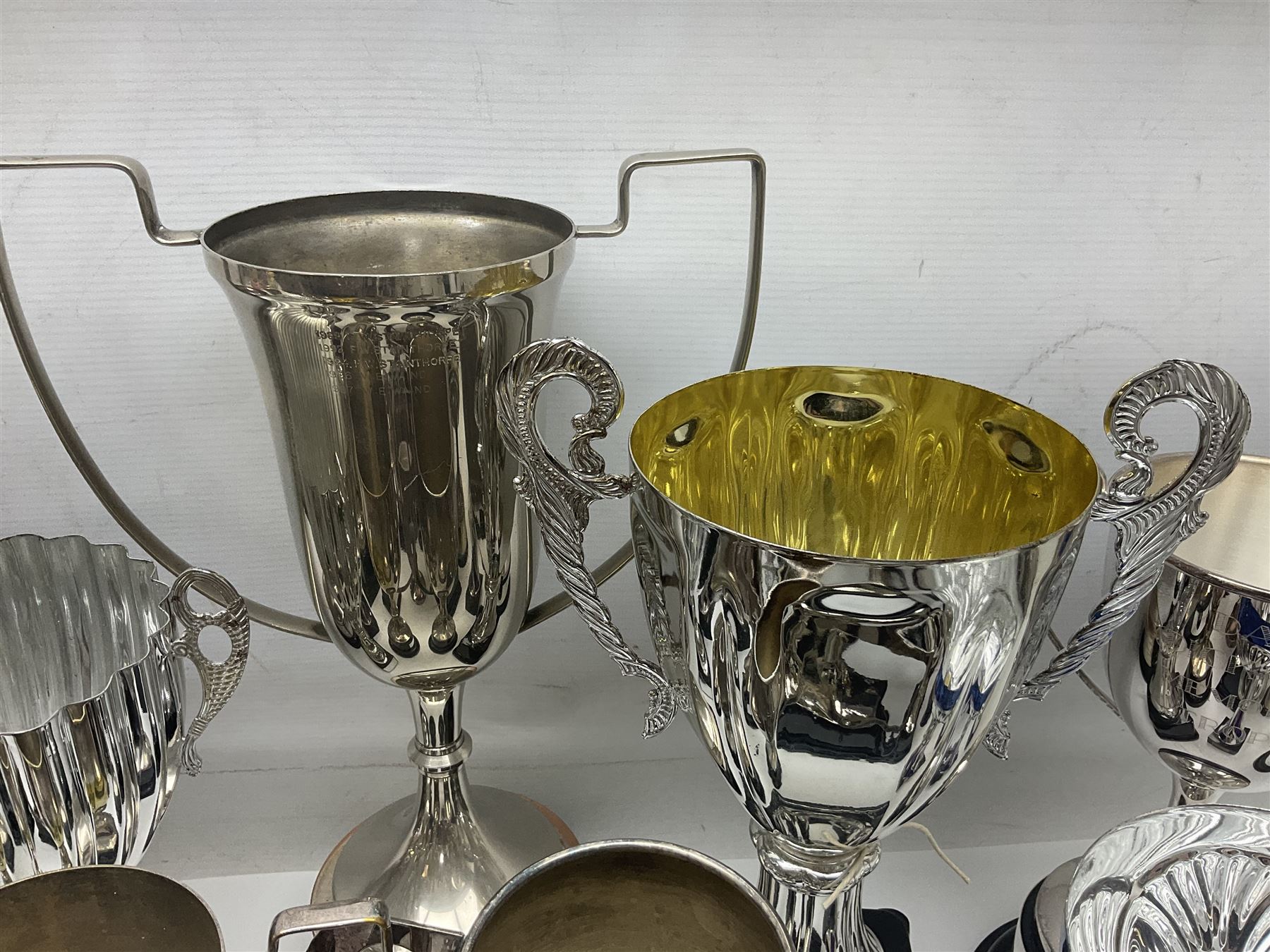 Collection of silver plated and metal trophy cups and winners plaques, all relating to the Burniston and District Show, most engraved with competitions and winner's names, in three boxes 