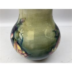 Moorcroft vase of baluster form decorated in the Spring Flowers pattern upon a merging green and blue ground, with impressed and painted marks beneath, H22.5cm