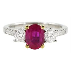 18ct white gold three stone oval ruby and round brilliant cut diamond ring, with diamond set shoulders and gallery, stamped 750, ruby 0.89 carat, total diamond weight approx 0.55 carat