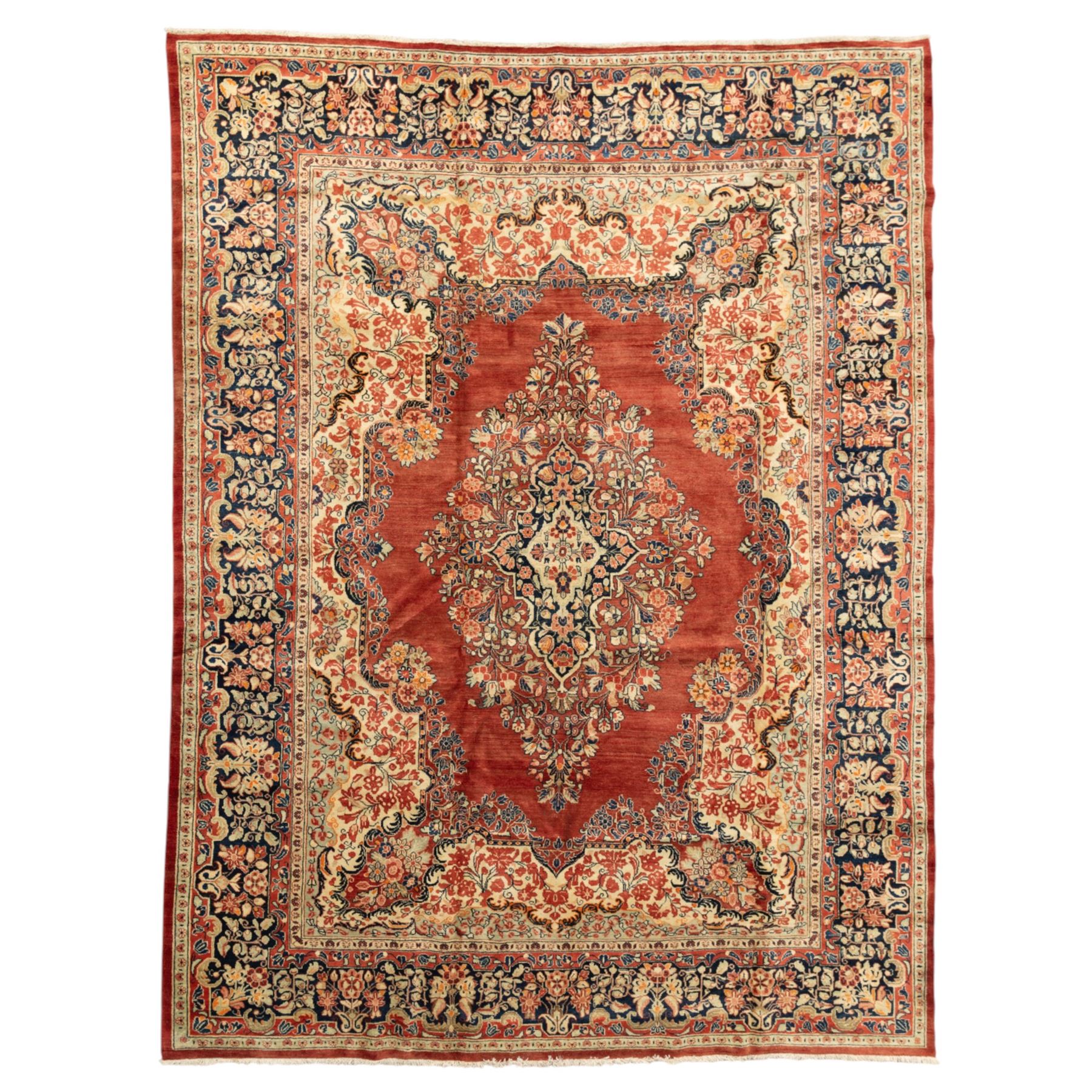 West-Central Persian Mahal hand-knotted carpet, terracotta field with a large central indigo and ivory medallion with floral palmettes and scrolling vines, framed by ivory spandrels with dense foliage within a broad navy border of lotus and palmette motifs linked by scrolling tendrils and multiple guard stripes 