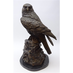  Large bronze model of a Peregrine Falcon perched on rocky base, shaped marble plinth, H60cm   