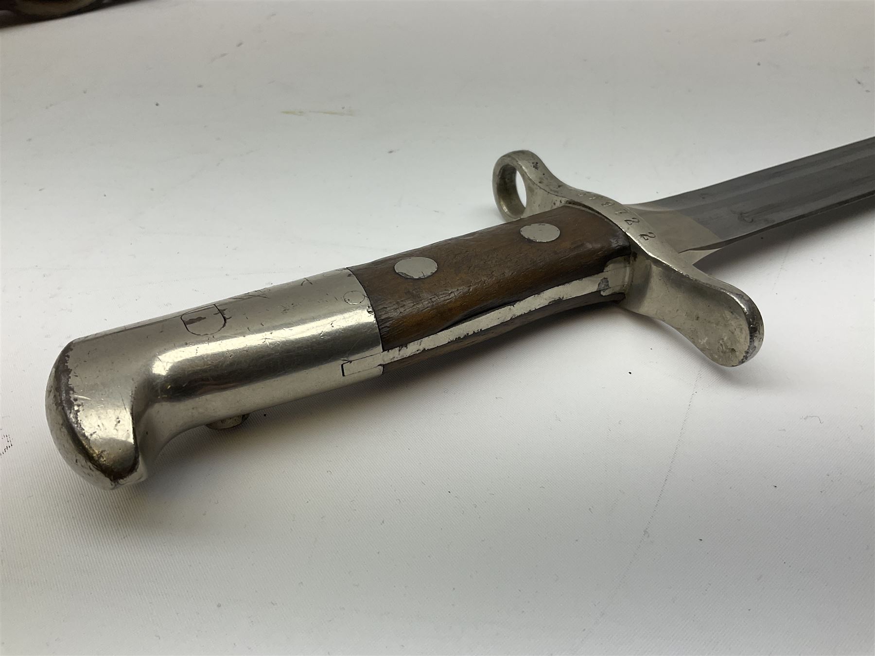 British Enfield 1907 model SMLE bayonet, with 43cm fullered steel blade and metal mounted leather scabbard L58cm overall; and Schmidt-Rubin Model 1918 bayonet the 30cm steel blade marked Elsener Schwyz No.579722; in steel scabbard with leather frog marked G. Bertolini Sellaio Vira/G.Tic 79 L45cm overall (2)