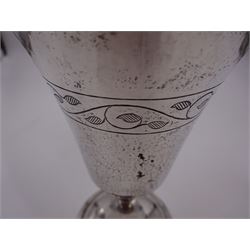 Modern limited edition silver goblet, a replica of the original silver chalice of Lincoln Cathedral, with hand planished decoration, and engraved band of laurel leaves to bowl, with gilt interior, upon waisted stem and circular stepped foot, no. 144/200, hallmarked John Cussell, London 1977, H15cm