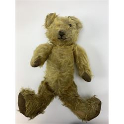 Early 20th century English teddy bear, WW1 period, with wood wool filled mohair body, fixed head with one boot button eye and vertically stitched nose and mouth and jointed limbs with cloth paw pads H16
