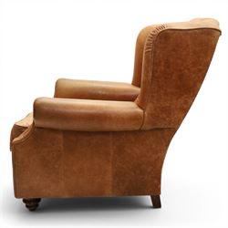 TETRAD for John Lewis - brown leather upholstered wingback armchair, button back with diamond tufted detail, loose seat cushion with piped edge, scroll arms and padded side wings, on short supports