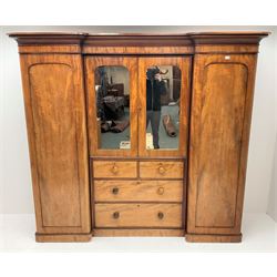 Victorian mahogany triple combination wardrobe, projecting cornice above two full length doors, flanking two mirrored doors enclosing four linen slides above two short and two long graduating drawers, plinth base 