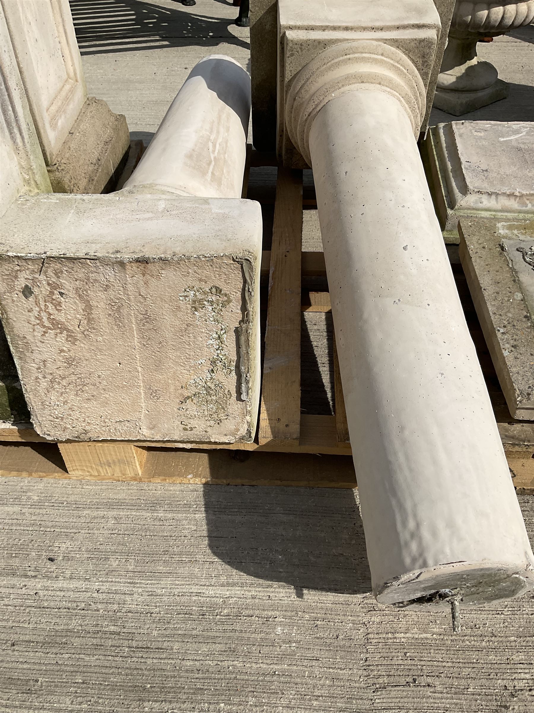 Set of four cast stone architectural columns, tapering form, on square plinth bases