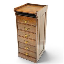 Edwardian oak pedestal filing cabinet, rectangular top with raised three-quarter gallery top, fitted with six drawers with interior paper-stays and brass handles, on plinth base