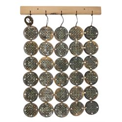 Attributed to Hornsea Pottery wall hanging, with 30 geometric circles attached to a wooden beam, H70cm 