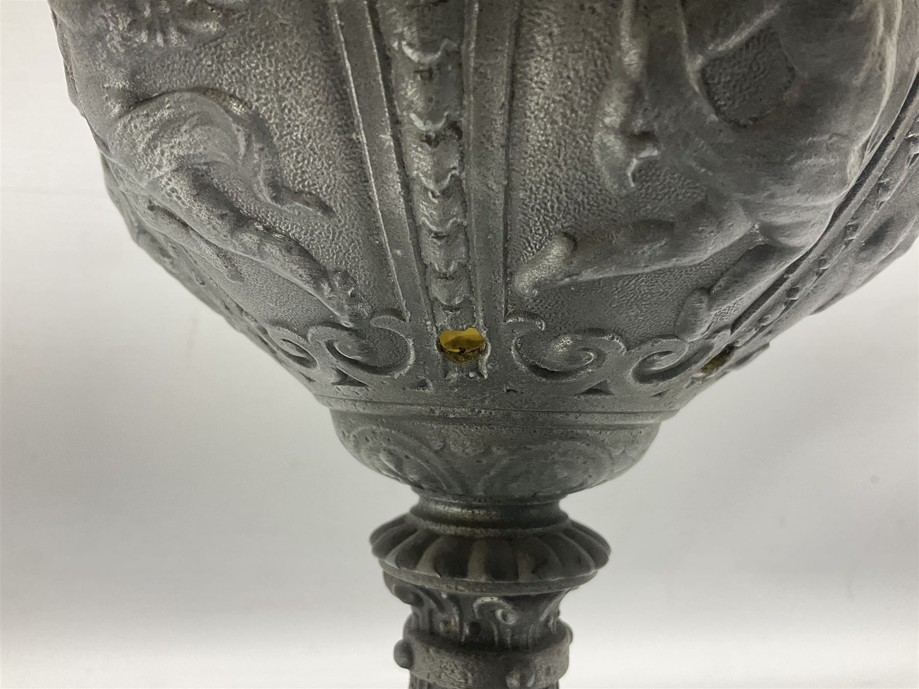 Victorian cast spelter oil lamp, decorated with cherubs and foliate scrolls, supporting a glass reservoir, burner and clear glass chimney, H62cm