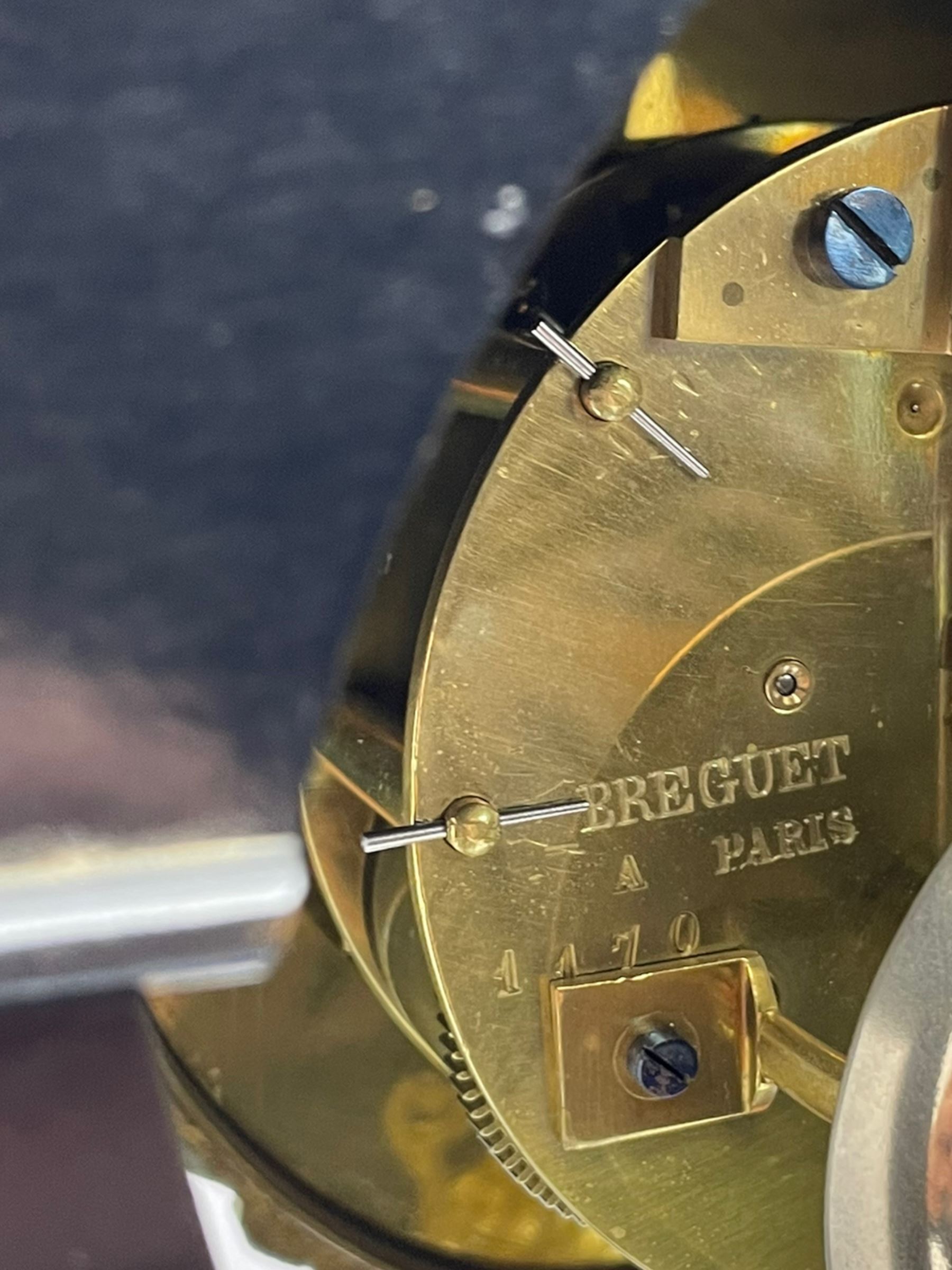 Breguet A Paris - Mid-19th century 8-day French portico clock, ebonised case with brass and cloisonne inlay, on a rectangular plinth with a shaped base, white enamel dial with blue Roman numerals, minute track and steel trefoil hands, cast brass bezel with scroll and foliate decoration and a conforming gridiron pendulum, twin train going barrel movement with a countwheel strike sounding the hours and half-hours on a bell, with an ebonised base and glass dome. 