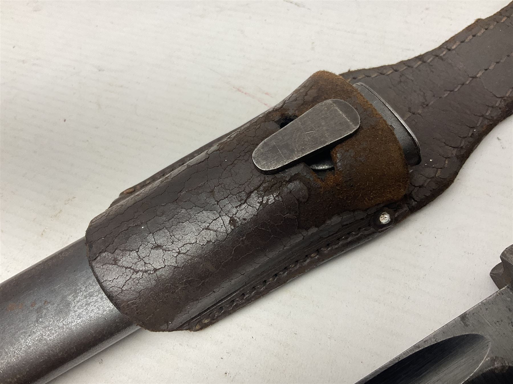 WWII German K98 Mauser bayonet by E. & F. Horster, the 24.5cm fullered blade marked 43aSW for 1943, numerous inspection marks to blade and pommel, bakelite grips and bluing to metal parts; in steel scabbard with corresponding numbers and leather frog L42cm overall