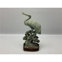 Chinese soapstone figure of a crane, upon a carved wooden plinth, together with another soapstone figure of a bird, tallest example 33cm  
