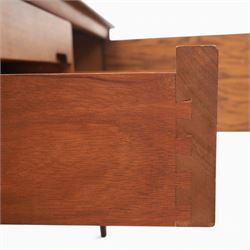 John Herbert for Youngers - 'Fonseca' mid-century teak sideboard, rectangular top above a central bank of three drawers one fitted for cutlery, flanked by cupboards with fixed shelved interior, raised on tapering supports 