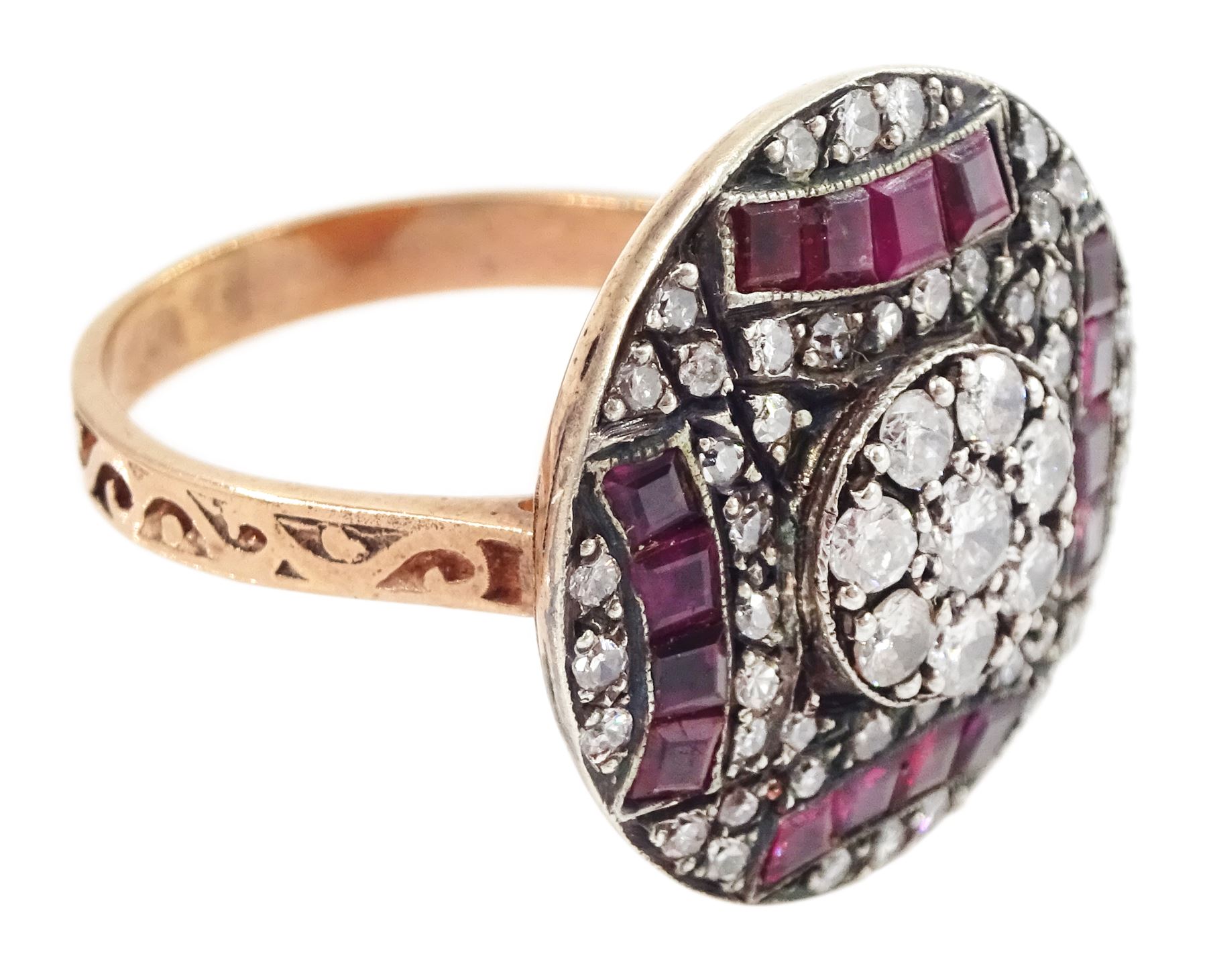 Rose gold and silver ruby and diamond circular ring, the central cluster set with eight round brilliant cut diamonds, with calibre cut ruby and single cut diamond surround, total diamond weight approx 0.90 carat, total ruby weight approx 0.75 carat