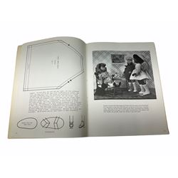 Heidi Ott doll in tartan dress, navy floral dress with white lace and ribbon detailing, striped blue and white dress and a 'Head to Toe' book