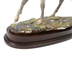 Two Royal Doulton horses, Desert Orchid and Red Rum, on wooden plinths 