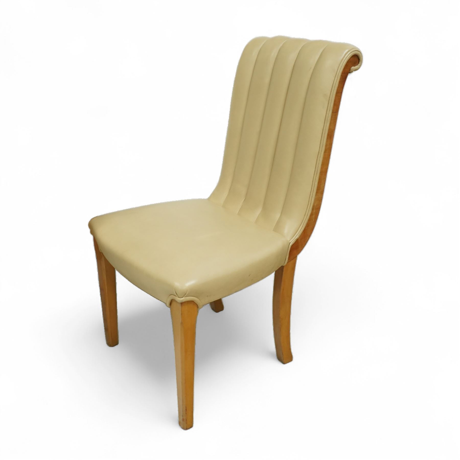 In the manner of Harry & Lou Epstein - Art Deco figured walnut veneered dining table, rectangular top with canted corners and glass protective top, edge with gently canted profile, on two rounded drum-shaped pedestals together with a set of four mid-century style walnut chairs, with elegant scroll and walnut veneered backs, upholstered in a light cream leather, 54x44x96cm