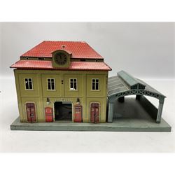 '0' gauge - Bing tin-plate two-storey double sided station with open walk-through to one end, rail side canopy, hinged doors and removable roof giving access to clock illumination L35cm; Bing hand-cranked turntable and open wagon; Marklin tin-plate level crossing barrier and Newspaper vendor's tin-plate four-wheel hand cart (5)