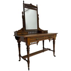 Late Victorian Aesthetic Movement walnut and inlaid ebony dressing table, swing mirror back with shell carving and spindle support rail, fitted with two trinket drawers and single frieze drawer, raised on ring turned supports with castors