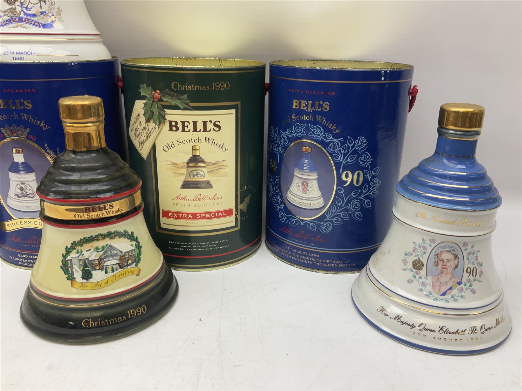Bells, Scotch whisky, in seven Wade ceramic decanters, comprising two Christmas decanters 1990 and 1991, 60th birthday of Queen Elizabeth II decanter, Golden Wedding anniversary of the Queen and the Duke of Edinburgh decanter, Birth of Princess Beatrice decanter, Birth of Princess Eugenie decanter and Queen's mothers, together with Bells, blended Scotch whiskies, three miniatures in Wade ceramic decanters, various contents and proofs