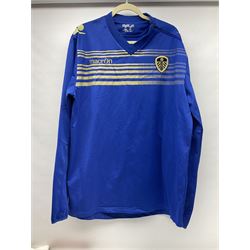 Fourteen items of replica sporting clothing including Leeds United football club shirts, England jerseys etc