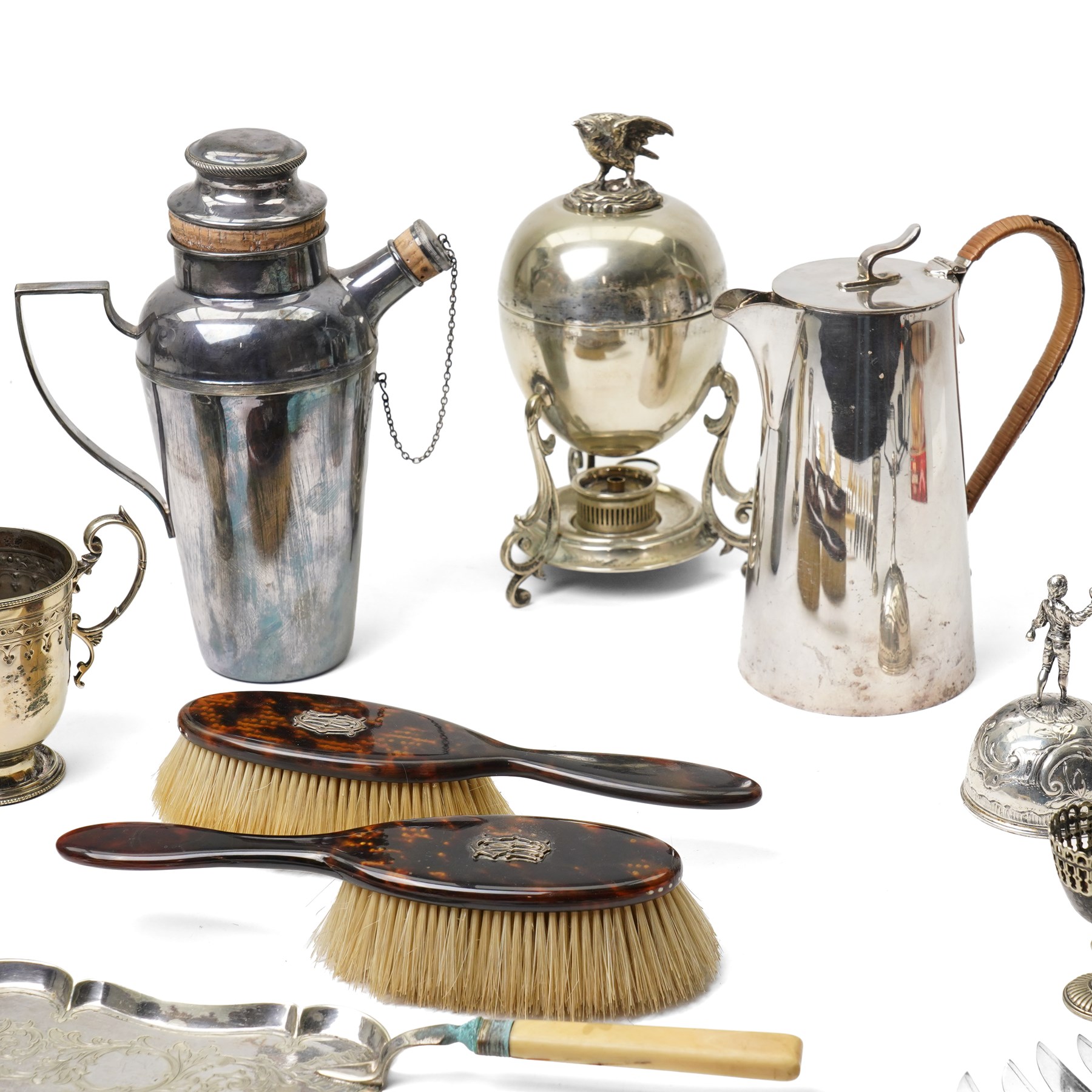 Silver plated egg boiler with bird finial, plated cocktail shaker, plated table bell, pair of tortoiseshell brushes' plated dessert knives and forks and other items 