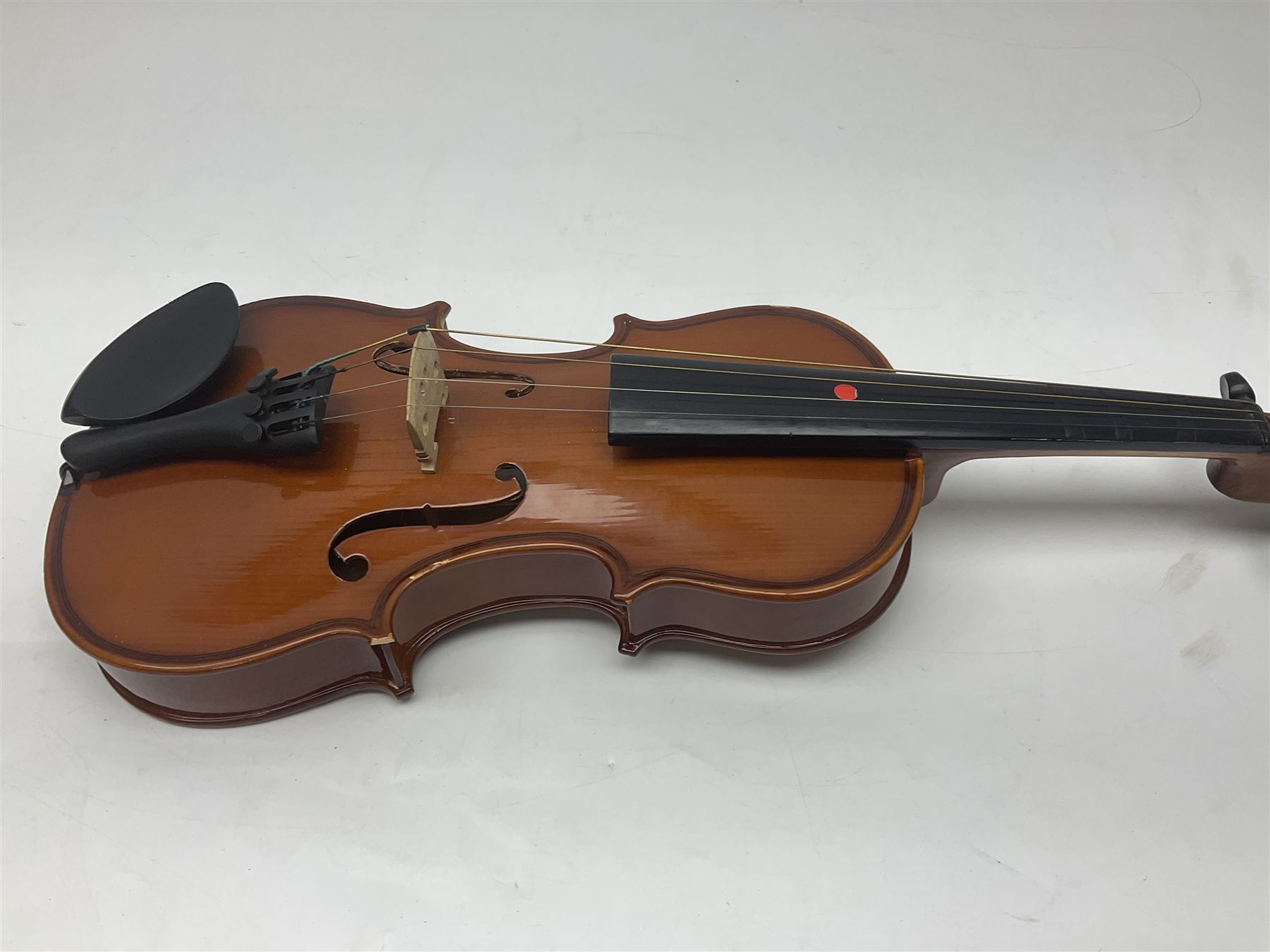 Four Chinese graduated violins - full size with 35.5cm two-piece back; three-quarter size with 33.5cm two-piece back; half size with 31cm two-piece back; and quarter size with 27.5cm two-piece back; all cased except full size; one with bow (4)