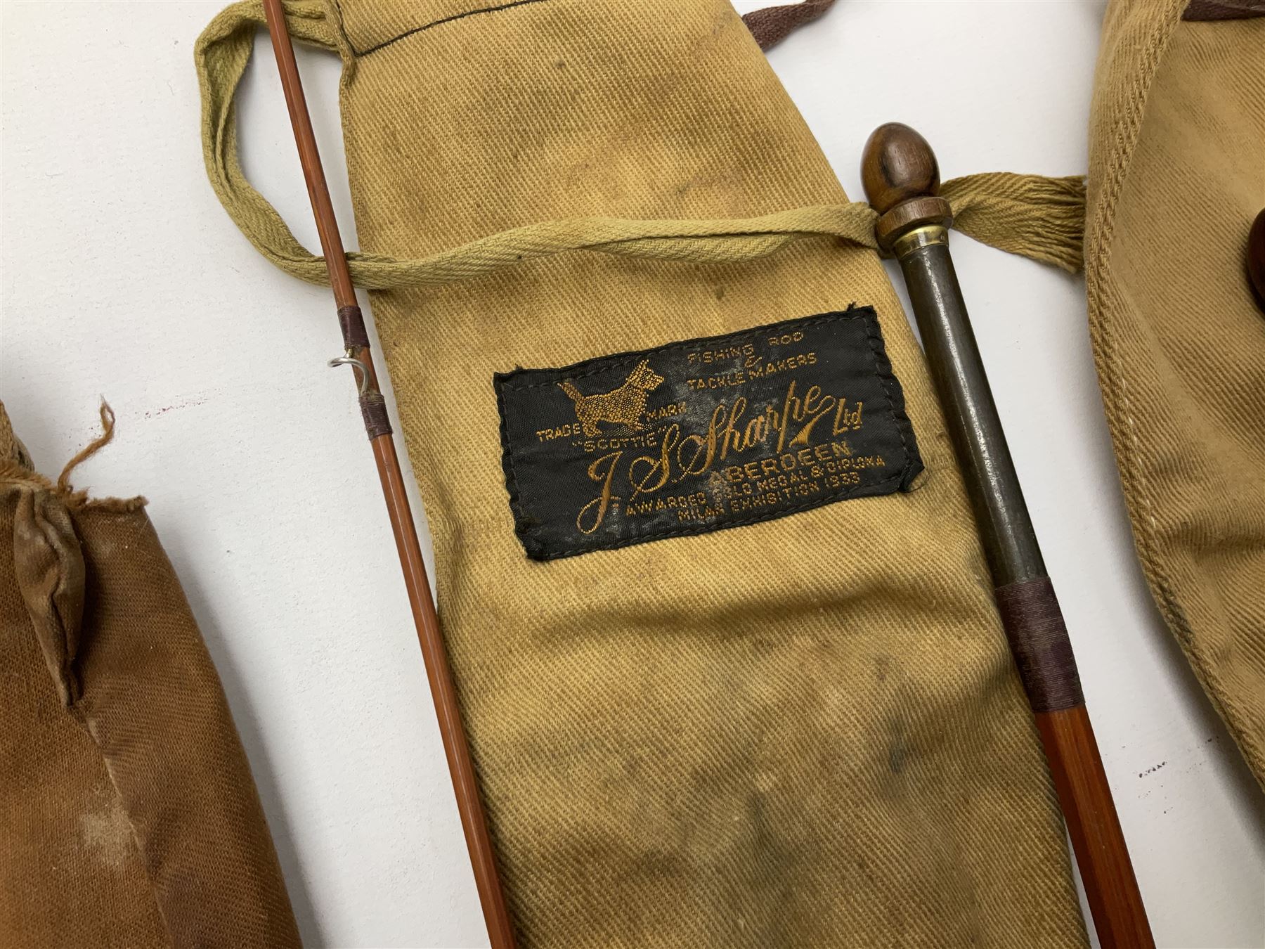 Four vintage split cane fishing rods in cloth bags, to include the Scottie Impregnated JS Sharpe rod and Pezon et Michel Farlow rod (4)