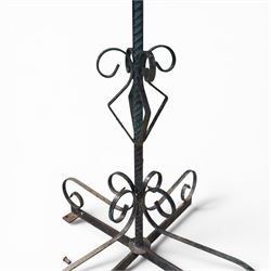 Matched pair of antique metal plant stands, each with circular strapwork basket tops, the scrollwork supports raised on an X-form base, in green painted finish with rustic patina