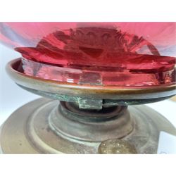 20th century brass oil lamp, with large honeycomb cranberry glass shade, H44cm