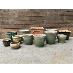 Pair of cast stone seated garden lions, a stone bird bath and various pots and planters