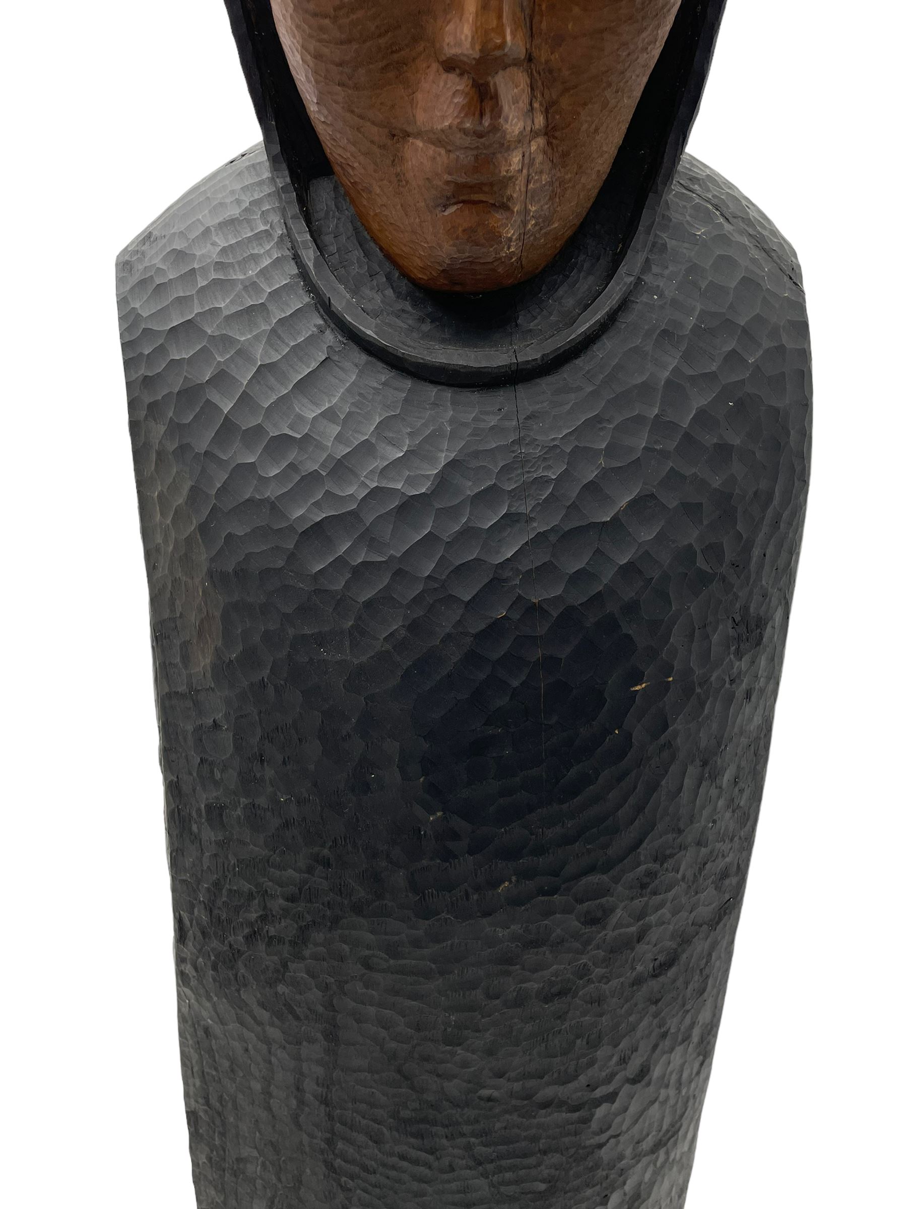 John Bunting FRBS, FRCA (1927-2002): Carved sculpture of a standing Monk in ebonised robes