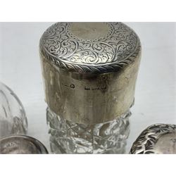 Five hallmarked silver mounted glass containers