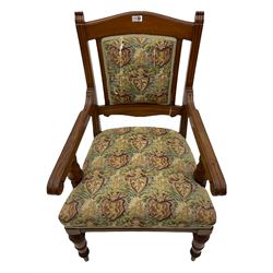 Late Victorian walnut elbow armchair, moulded frame and turned supports, upholstered seat and back in heraldic patterned fabric