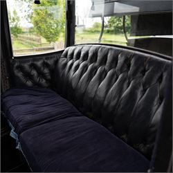 Town Coach by John Marstons Birmingham - Ex Film

A black painted five glass Town Coach by John Marston's Carriage Works Ltd, Birmingham, with enclosed glazed passenger compartment, curved front glass, external coachman's box seat and pole for driving with a pair of horses. The carriage has a timber coach body with buttoned black leather interior, blue upholstered seat cushions, plated exterior door handle, maker plates to the body and step, and John Marston marked hub caps. Mounted on black painted wooden spoked wheels with rubber tyres, leaf spring suspension, underbody turntable steering and iron fittings throughout.
Featured on the film set of 'Victoria' with Jenna Coleman

Features

• Black painted enclosed coach body
• Glazed passenger compartment with five windows
• Curved front glass
• Buttoned black leather interior
• Blue upholstered seat cushions
• External coachman's box seat
• Timber coach body
• Wooden spoked wheels
• Rubber tyres
• Leaf spring suspension
• Underbody turntable steering
• Pole for pair of horses
• Iron foot steps
• Plated exterior door handle
• Maker plates for John Marston's Carriage Works Ltd, Birmingham
• John Marston marked hub caps
• Featured on the film set of Victoria with Jenna Coleman

Dimensions:
Overall length: 390 cm
Width: 190 cm
Height: 214 cm

Wheel Diameters:
Front wheels: 104 cm
Rear wheels: 134 cm

Seating:
Coachman's box: 2
Passenger compartment: 4