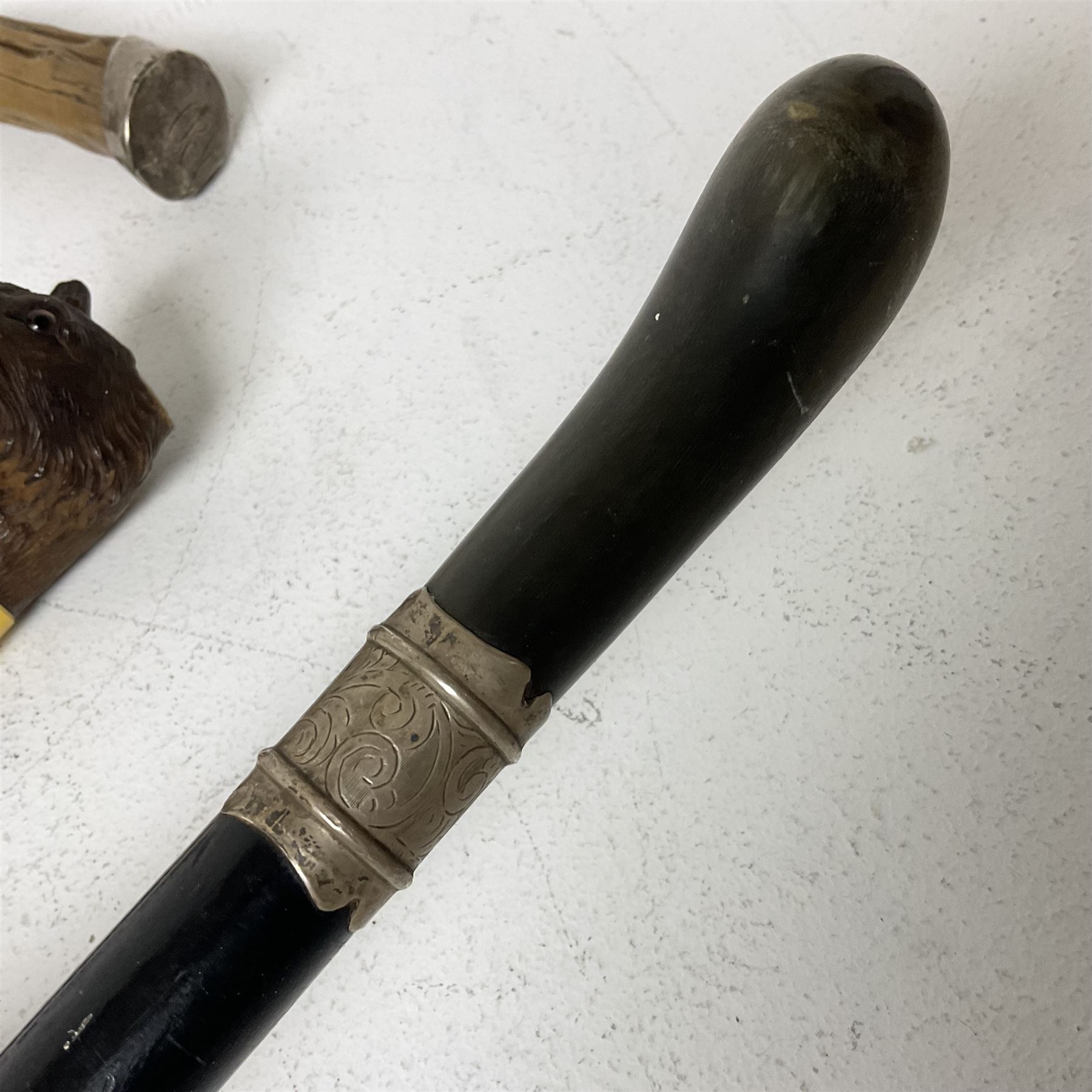 19th century painted bamboo walking cane, the handle carved as a fox with glass eyes, with gilt metal stamped LB, together with an ebonised wooden walking stick, with horn pommel and hallmarked silver collar and a curved wooden walking stick, with monogrammed white metal cap, tallest L90cm