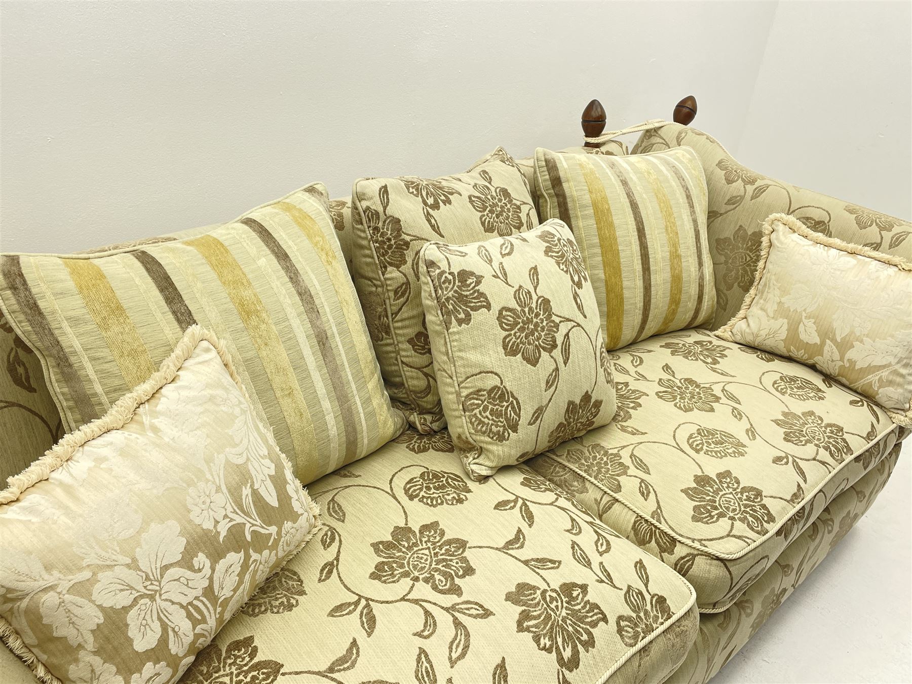 Grande Knole drop arm three seat sofa upholstered in pale fabric with raised floral pattern, with feather scatter cushions