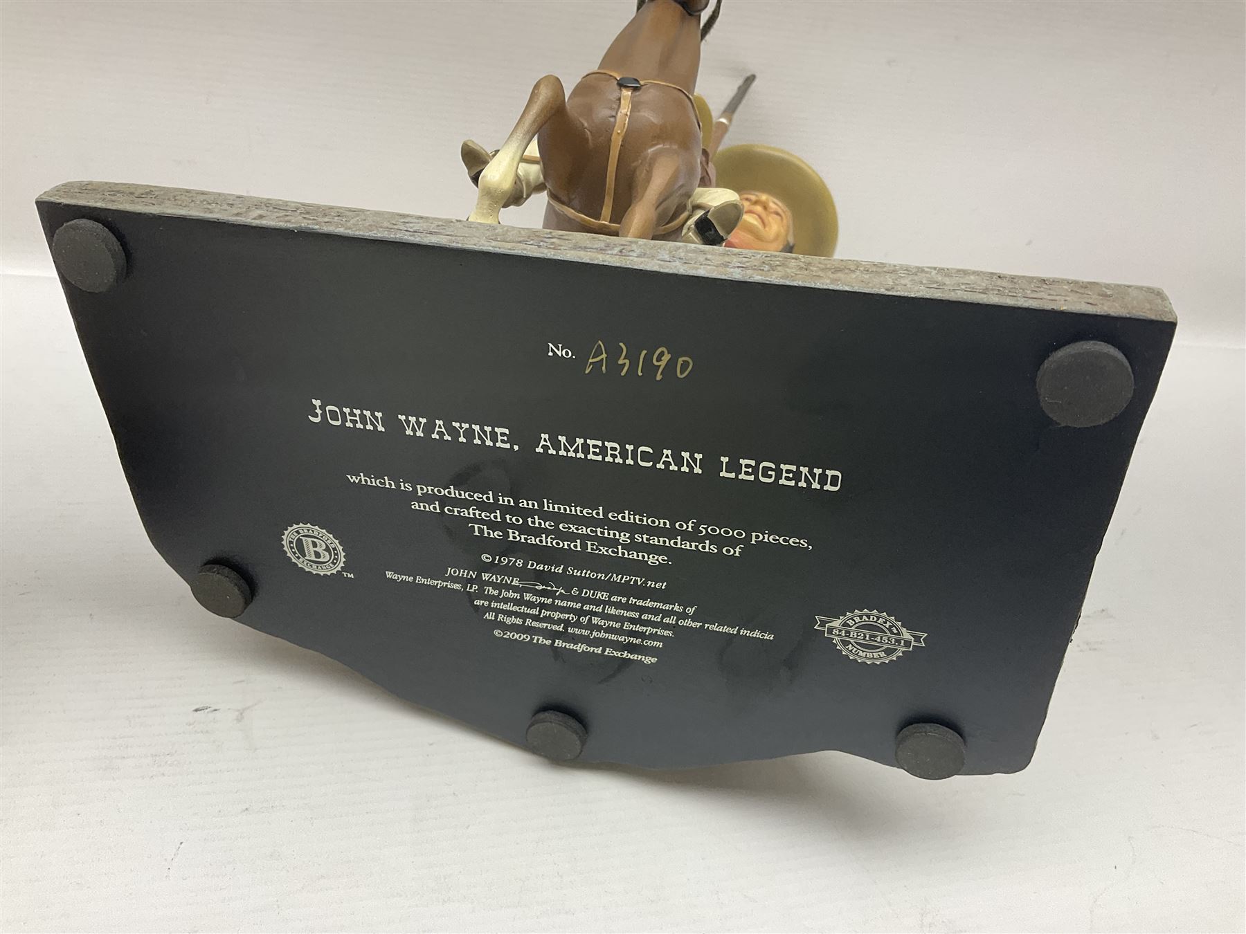 Beswick matte Hereford Bull, with stamped mark beneath, on wooden plinth, together with a limited edition Bradford Exchange John Wayne model, tallest H36cm