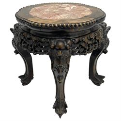 Early 20th century Chinese hardwood and marble top jardinière or urn stand, shaped circular top with bead edge over pierced and carved foliate rails, the supports carved with dragon masks and fanned foliate decoration, on ball and claw feet