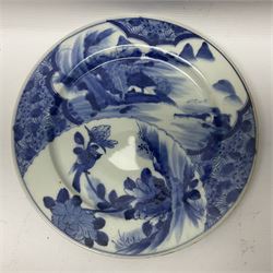 Japanese Meiji period Arita blue and white plate, of circular form, painted with riverside landscape and bird upon flowering branch, with character mark beneath, D24.5cm, together with two 18th century Chinese blue and white plates, each painted with floral design, each approximately D22.5cm