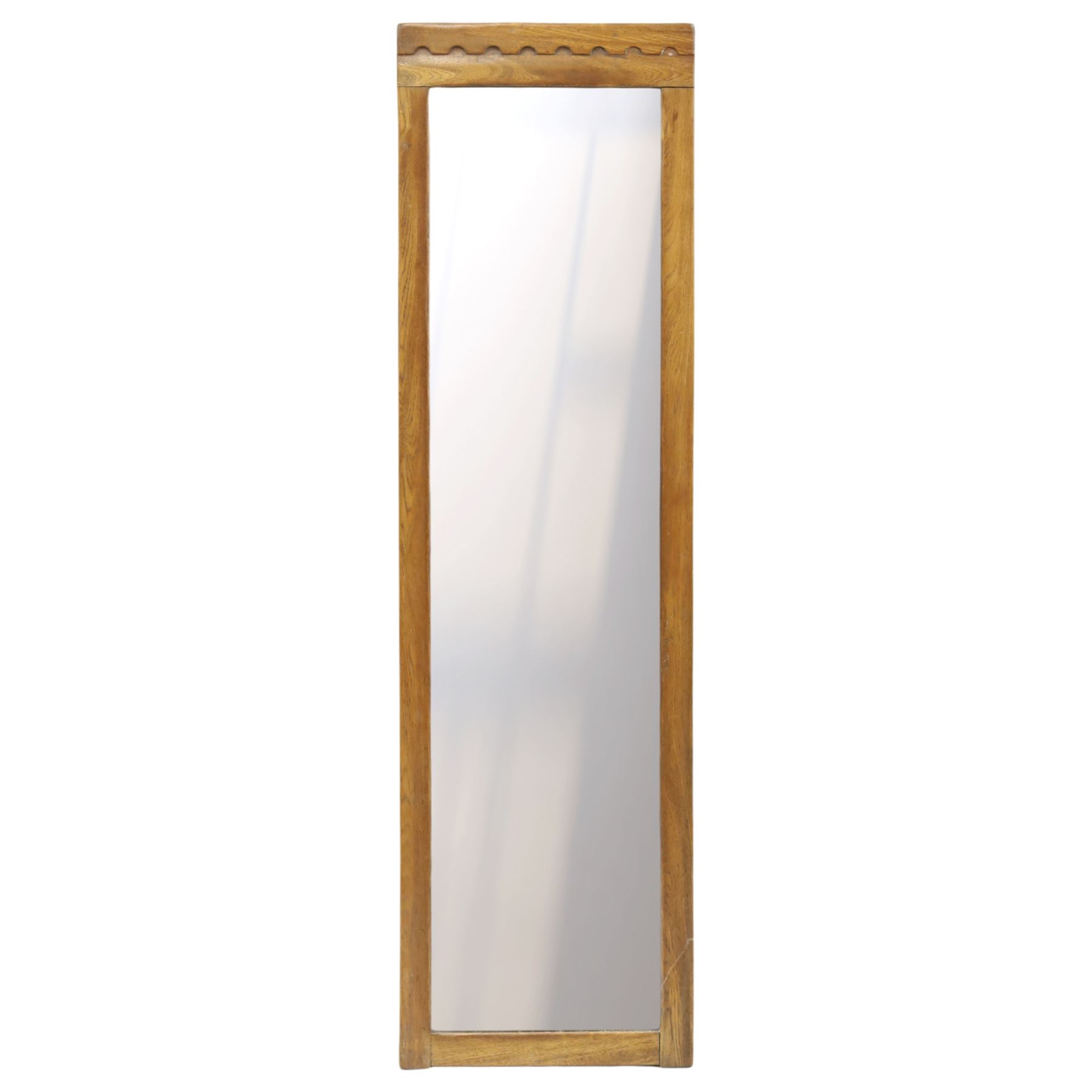 In the manner of  Yorkshire Critters - oak framed rectangular wall mirror, plain frame with carved arcade decoration to the cresting rail