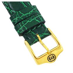 Gucci ladies gold-plated quartz wristwatch, Ref. 2600 L, silvered and green dial, on original green leather strap with gilt buckle, boxed