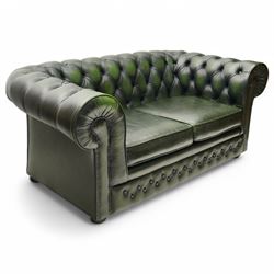 Thomas Lloyd - two-seat hardwood-frame Chesterfield sofa, traditional rolled back and arms upholstered in deeply buttoned green leather, on turned bun feet 