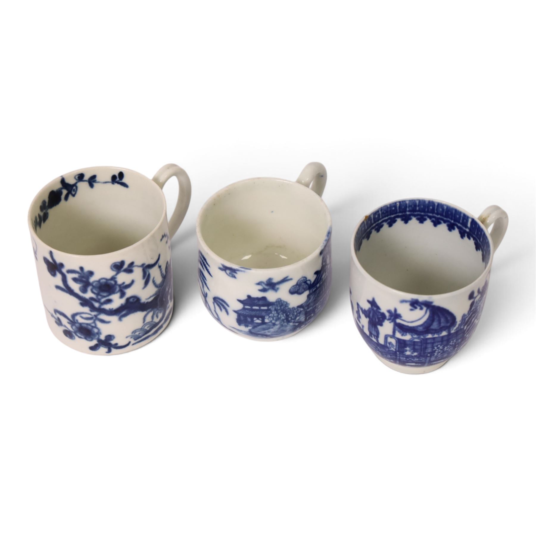 Worcester blue and white coffee cup, decorated in the Fisherman or Pleasure Boat pattern, circa 1775, together with a Worcester blue and white coffee can, decorated in the Prunus pattern, circa 1770-1775, and a Caughley blue and white custard cup, decorated in the Willow Nankin pattern, circa 1784-1792, each with marks beneath, custard cup H5.5cm